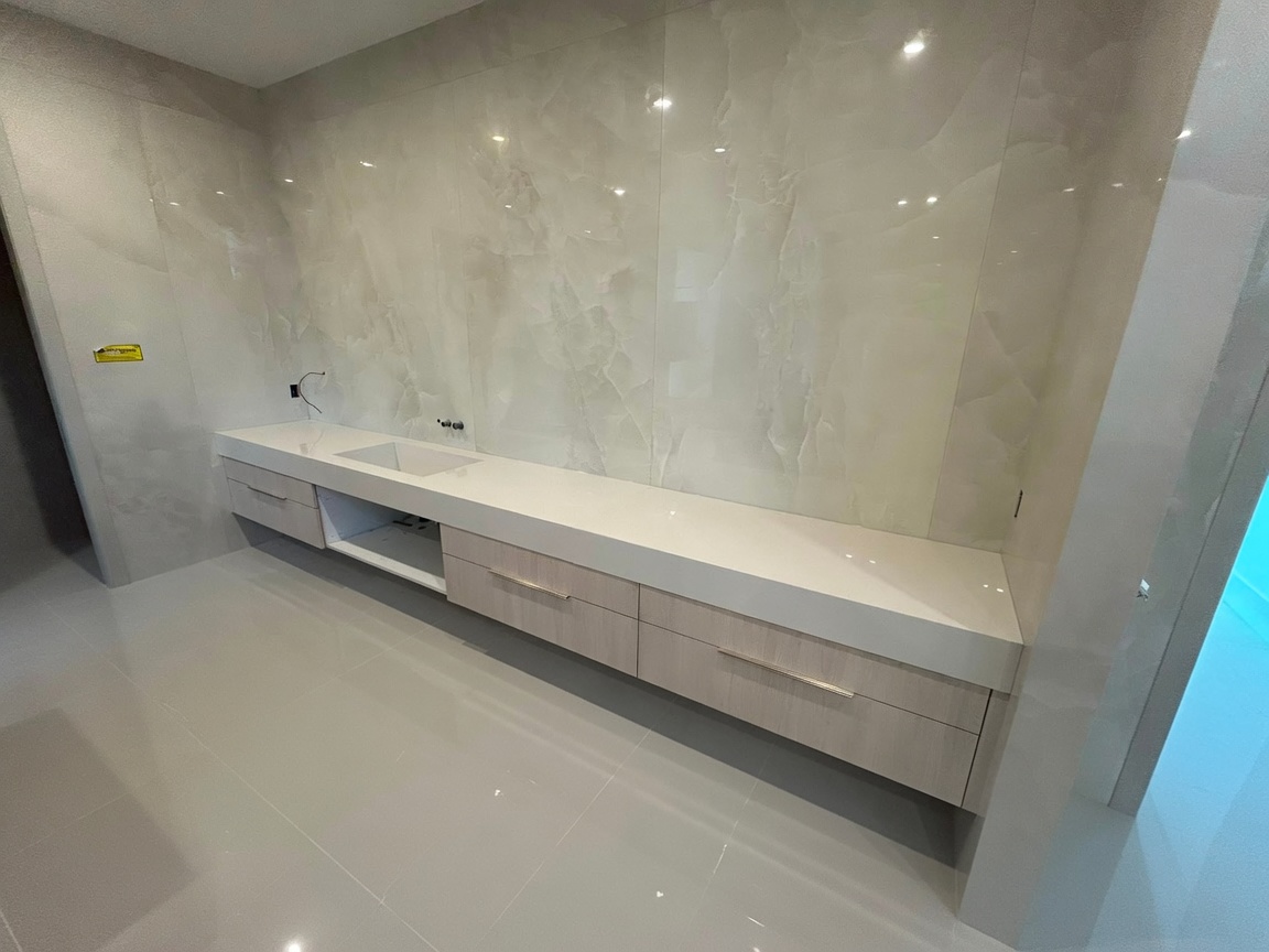 Bathroom vanity with full-height marble wall tile